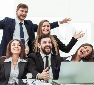 closeup of triumphant business team near the desktop, on the background of the office