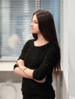 young employee standing near the window in the office.photo with copy space