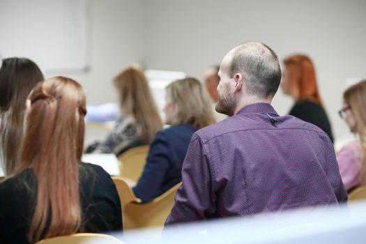 rear view.businessman sitting in a conference room.concept of education