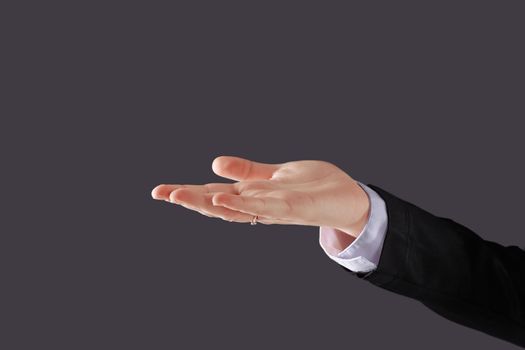 close up. business woman showing open palm .isolated on black background.