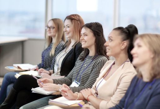 group of business people listening to a lecture at a business seminar