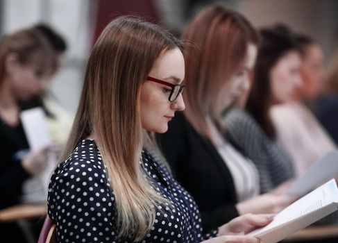 group of business people with documents sitting at the lecture hall.concept of education