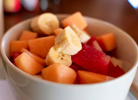 A bowl of fruit salad, close up of banana salad with fruits, healthy fruits concept