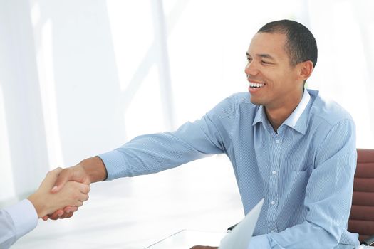 closeup. businessman shaking hands with his partner.photo with copy space .