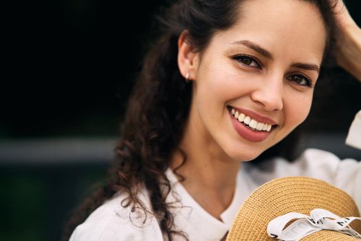 Young beautiful girl in a hat in a summer park. High quality photo