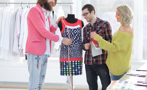 designers discussing new fabric patterns in a creative Studio.