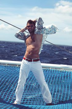 Man enjoying summer time holiday on sailing boat.