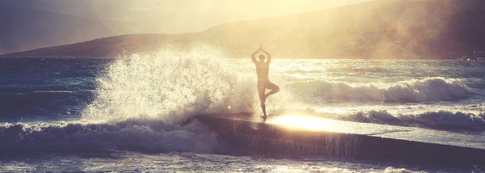 Feeling of freedom concept. Man standing on pier facing to the sea with big waves.