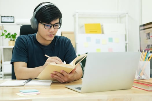 Young male student study at home. He using laptop and learning online.
