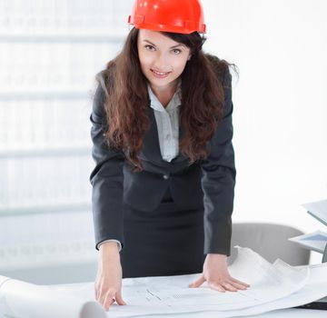 female architect working with blueprints in the office.photo with copy space