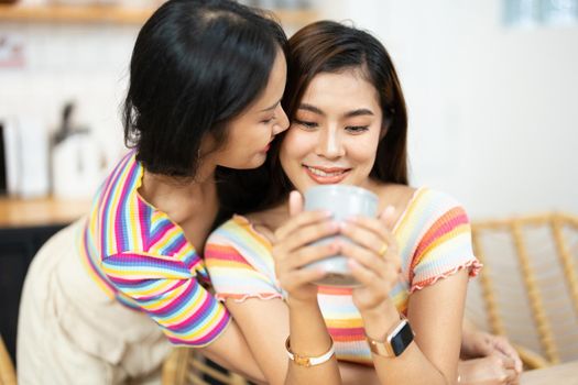 lgbtq, LGBT concept, homosexuality, portrait of two Asian women posing happy together and showing love for each other while having coffee at the dining table.