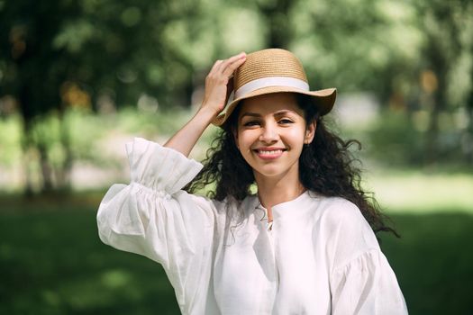 Young beautiful girl in a hat in a summer park. High quality photo