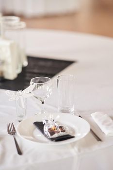 Table set for an event party or wedding reception. Empty wine glasses at a wedding celebration.