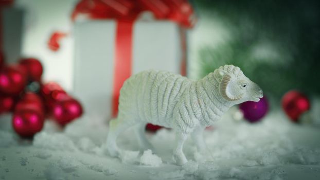 toy sheep and boxes with gifts on Christmas background .photo with copy space.