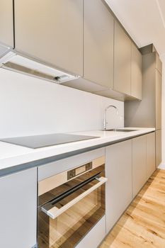 Interior of empty white kitchen and wooden parquet floor