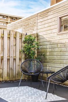 A set of stylish chairs and round table in the terrace of the house