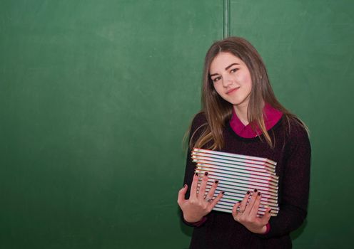 portrait of happy cute student near blackboard