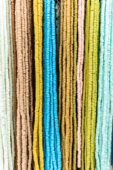 Strings of colorful bead necklaces are displayed for sale. High quality background photo