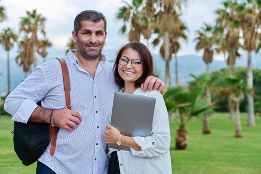 Portrait of a mature couple, smiling man and woman looking at the camera. Business, partners, family, owners, entrepreneurs concept