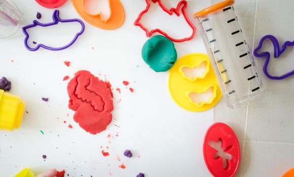 kid is playing with colourful plasticine in kindergarten. High quality photo