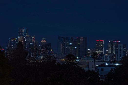 Night view of the city life. The light of the buildings shone with cool blue tones. View of night scene of Tel Aviv, Israel. Blue tone cityscape. High quality photo