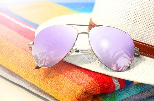 Summer vacation concept. Sunglasses with ocean beach and palms.