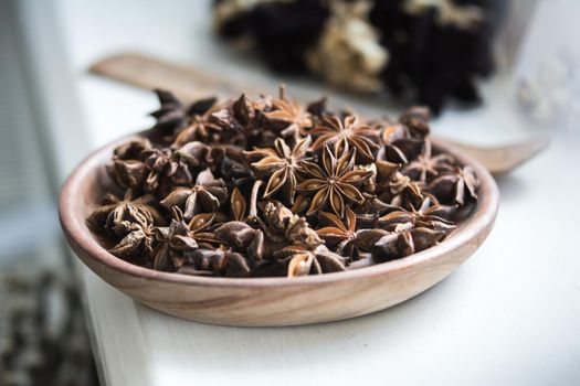 selected star anise stars on a wooden bowl. High quality photo
