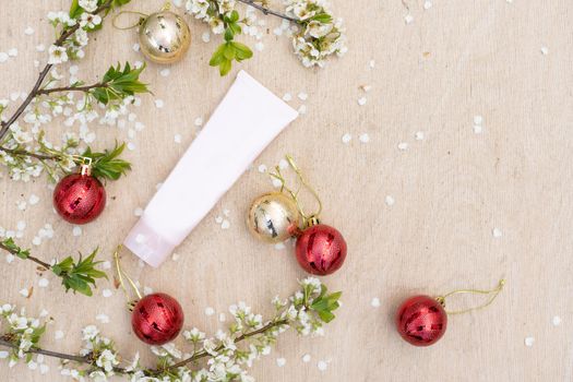 spring flowering tree branch. White plastic tube for branding and Christmas, New Year decoration. Product flat lay.