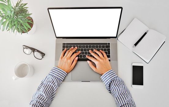 Close up of woman's hands typing on aloptop in an office or at home