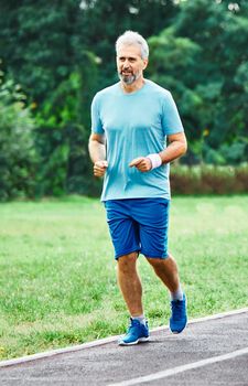 portrait of a senior man exercising and running outdoors