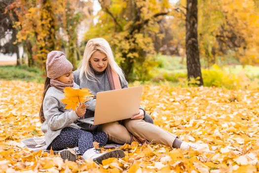 Autumn walk. mother and daughter are talking on video communication.