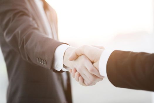 close up.business handshake over blurry background.business concept