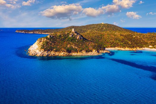Torre di Porto Giunco Tower and Simius Beach near Villasimius, Sardinia, Italy. View from flying drone. Torre di Porto Giunco tower on Carbonara cape. Aerial morning view of Sardinia island, Italy