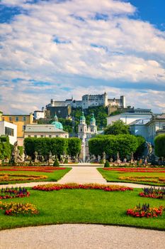 Beautiful view of famous Mirabell Gardens with the old historic Fortress Hohensalzburg in the background in Salzburg, Austria. Famous Mirabell Gardens with historic Fortress in Salzburg, Austria.