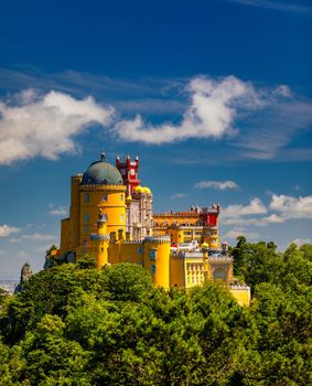 Famous historic Pena palace part of cultural site of Sintra against sunset sky in Portugal. Panoramic View Of Pena Palace, Sintra, Portugal. Pena National Palace at sunset, Sintra, Portugal. 