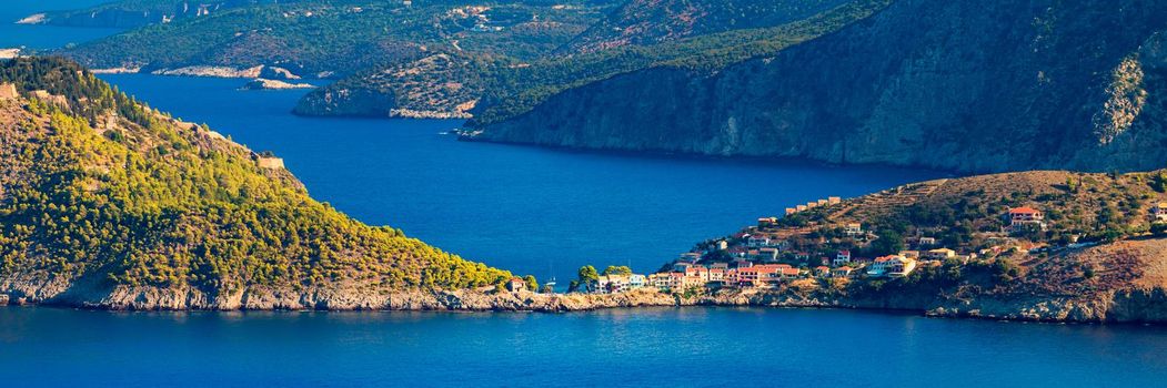 Assos village in Kefalonia, Greece. Turquoise colored bay in Mediterranean sea with beautiful colorful houses in Assos village in Kefalonia, Greece, Ionian island, Cephalonia, Assos village.