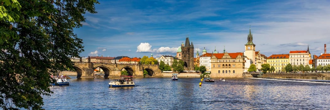 Prague in a sunny day, view of the old town, Prague, Czech Republic. Scenic summer view of the Old Town pier architecture and Charles Bridge over Vltava river in Prague, Czech Republic