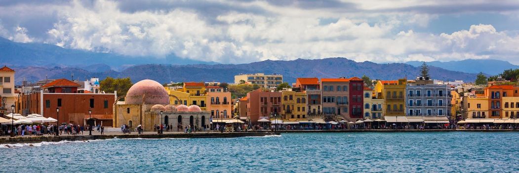 Mosque in the old Venetian harbor of Chania town on Crete island, Greece. Old mosque in Chania. Janissaries or Kioutsouk Hassan Mosque in Chania Crete. Turkish mosque in Chania bay. Crete, Greece.