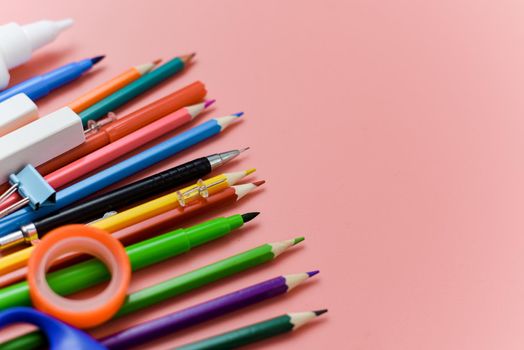 school supplies stationery on pink background. View from above.