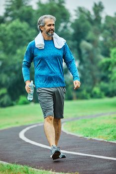 portrait of a senior man exercising and running outdoors