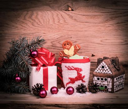 Christmas Cup,gingerbread house and a box of gifts .photo with space for text