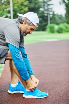 portrait of a senior man exercising and running outdoors