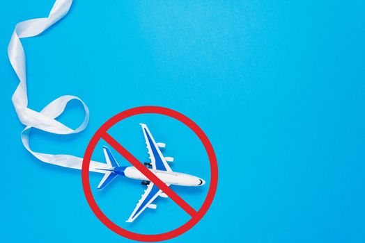 Ban on flights of civil aircraft. Prohibition sign. Cancellation of flights due to coronavirus. The sign of the ban and a miniature toy aircraft.