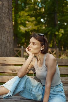 Portrait of a young american woman listening to music on cell phone.