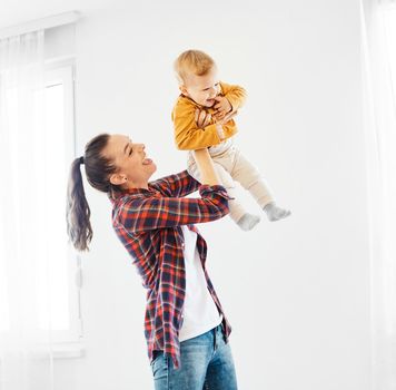 Portrait of a mother and son having fun together at home