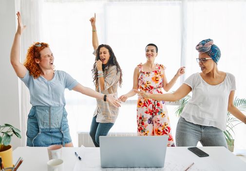 Happy young people friends dancing in the office