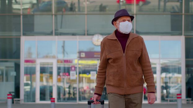 Senior one pensioner tourist male grandfather businessman wearing Protective Face Mask, avoid disease COVID-19 coronavirus infection near airport pandemic disease virus epidemic air health illness