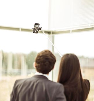 rear view of young company's employees make selfie in the lobby of the office