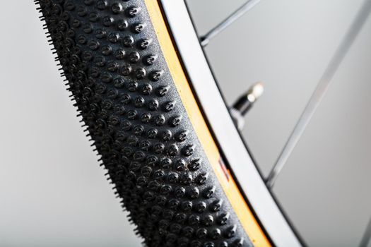 Shallow tread of a bicycle tubeless tire with a brown sidewall close-up