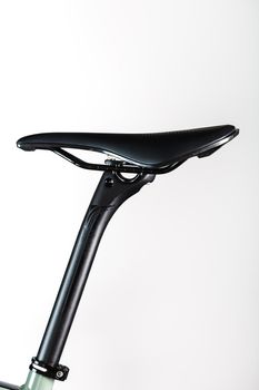 Bicycle saddle with seatpost on a light background accessories for bike repair and tuning